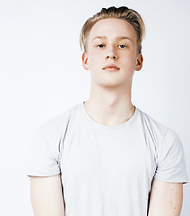 Image showing young handsome teenage hipster guy posing emotional, happy smiling against white background isolated, lifestyle people concept