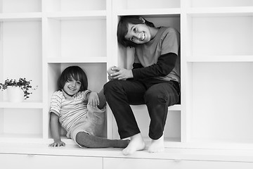 Image showing young boys posing on a shelf