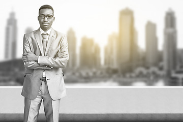 Image showing Young black businessman in front of the big city