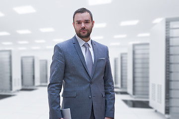 Image showing Young businessman in server room