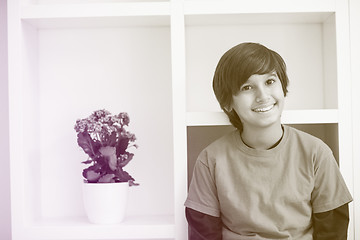 Image showing young boy posing on a shelf