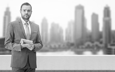 Image showing Young businessman in front of the big city