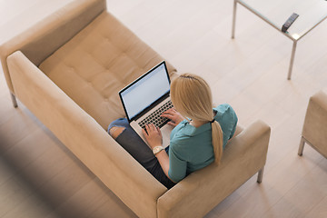 Image showing Young woman using laptop at home