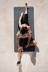 Image showing woman with personal trainer doing morning yoga exercises top vie