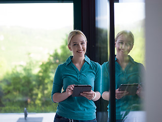 Image showing young women using tablet computer by the window