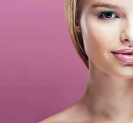 Image showing young pretty blonde woman with hairstyle close up and makeup on pink 