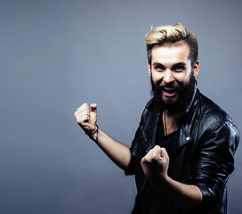 Image showing portrait of young bearded hipster guy on gray dark background close up, brutal modern man, lifestyle people concept 