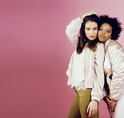 Image showing different nation girls with diversuty in skin, hair. Asian, scandinavian, african american cheerful emotional posing on pink background, woman day celebration, lifestyle people concept