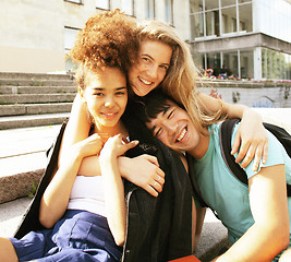 Image showing cute group of teenages at the building of university with books 