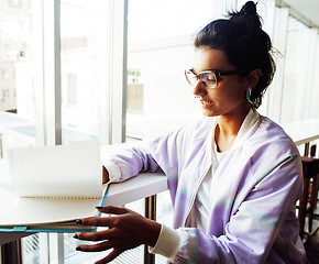 Image showing young cute hipster girl student sitting in cafe with notebook re