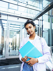 Image showing young cute indian girl at university building sitting on stairs 