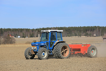 Image showing Ford 6610 Tractor and Seeder on Field at Spring