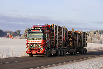 Image showing Red Volvo Logging Truck Hauls Log Load in Winter