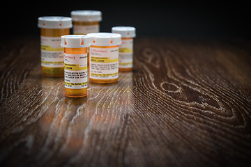 Image showing Variety of Non-Proprietary Prescription Medicine Bottles on Refl