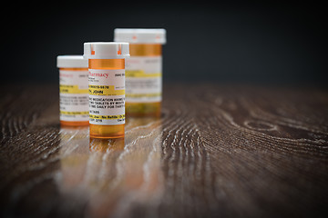 Image showing Variety of Non-Proprietary Prescription Medicine Bottles on Refl