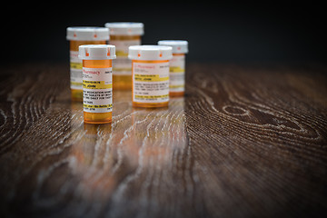 Image showing Variety of Non-Proprietary Prescription Medicine Bottles on Refl