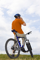 Image showing Man with bicycle making a phone call