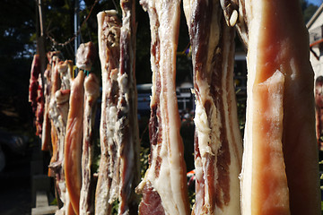 Image showing The suspended pieces of the meat drying outside