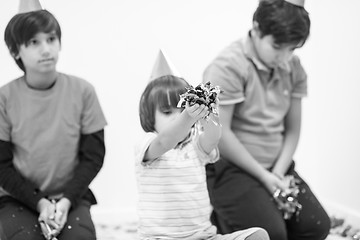 Image showing kids  blowing confetti