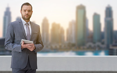 Image showing Young businessman in front of the big city