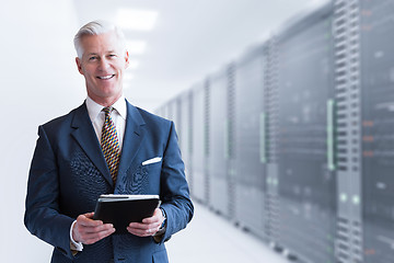 Image showing Senior businessman in server room