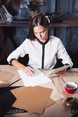 Image showing Young beautiful woman working with cup of coffee