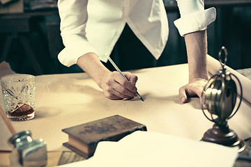 Image showing Architect working on drawing table in office