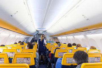 Image showing Stewardess serving passangers on Ryanair airplane flight on 14th of December, 2017 on a flight from Trieste to Valencia.