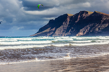 Image showing Surfers and kiters in the water on Famara beach, Lanzarote