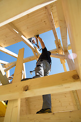 Image showing Builders at work with wooden roof construction.