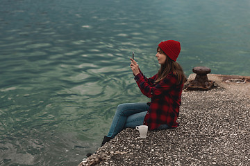 Image showing Woman taking pictures with a cellphone