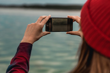 Image showing Woman taking pictures with a cellphone