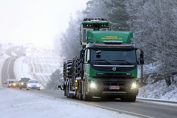 Image showing Volvo FMX Hauls John Deere Forestry Machinery in Winter