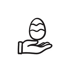 Image showing Hand holding easter egg sketch icon.