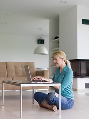 Image showing young women using laptop computer on the floor