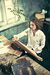 Image showing Architect working on drawing table in office