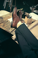 Image showing Architect working on drawing table in office