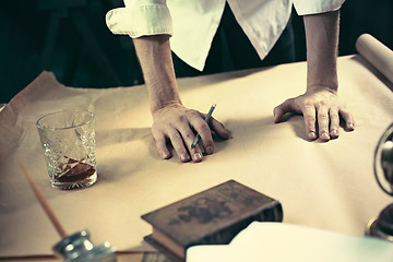 Image showing Architect working on drawing table in office