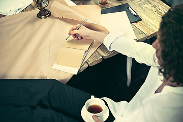 Image showing Architect working on drawing table in office