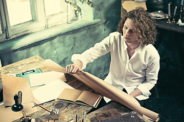 Image showing Architect working on drawing table in office