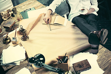 Image showing Architect working on drawing table in office