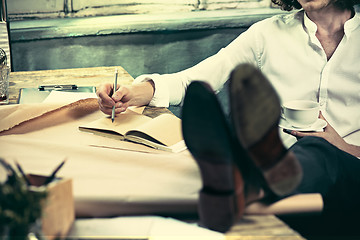 Image showing Architect working on drawing table in office