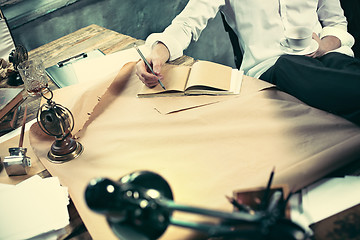 Image showing Architect working on drawing table in office