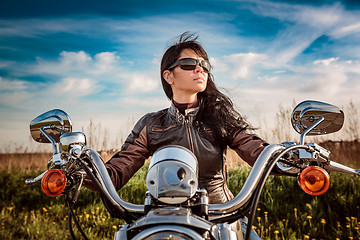 Image showing Biker girl sitting on motorcycle