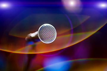 Image showing Microphone on stage against a background of auditorium.