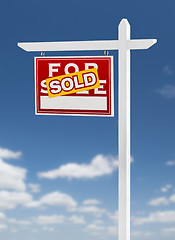 Image showing Left Facing Sold For Sale Real Estate Sign on a Blue Sky with Cl