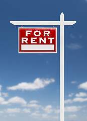 Image showing Left Facing For Rent Real Estate Sign on a Blue Sky with Clouds.