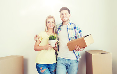 Image showing smiling couple with big boxes moving to new home