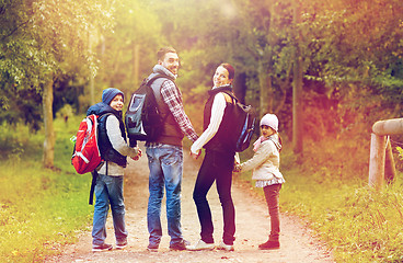 Image showing happy family with backpacks hiking walking