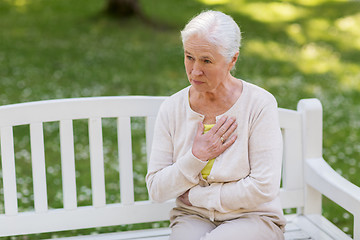 Image showing senior woman feeling sick at summer park